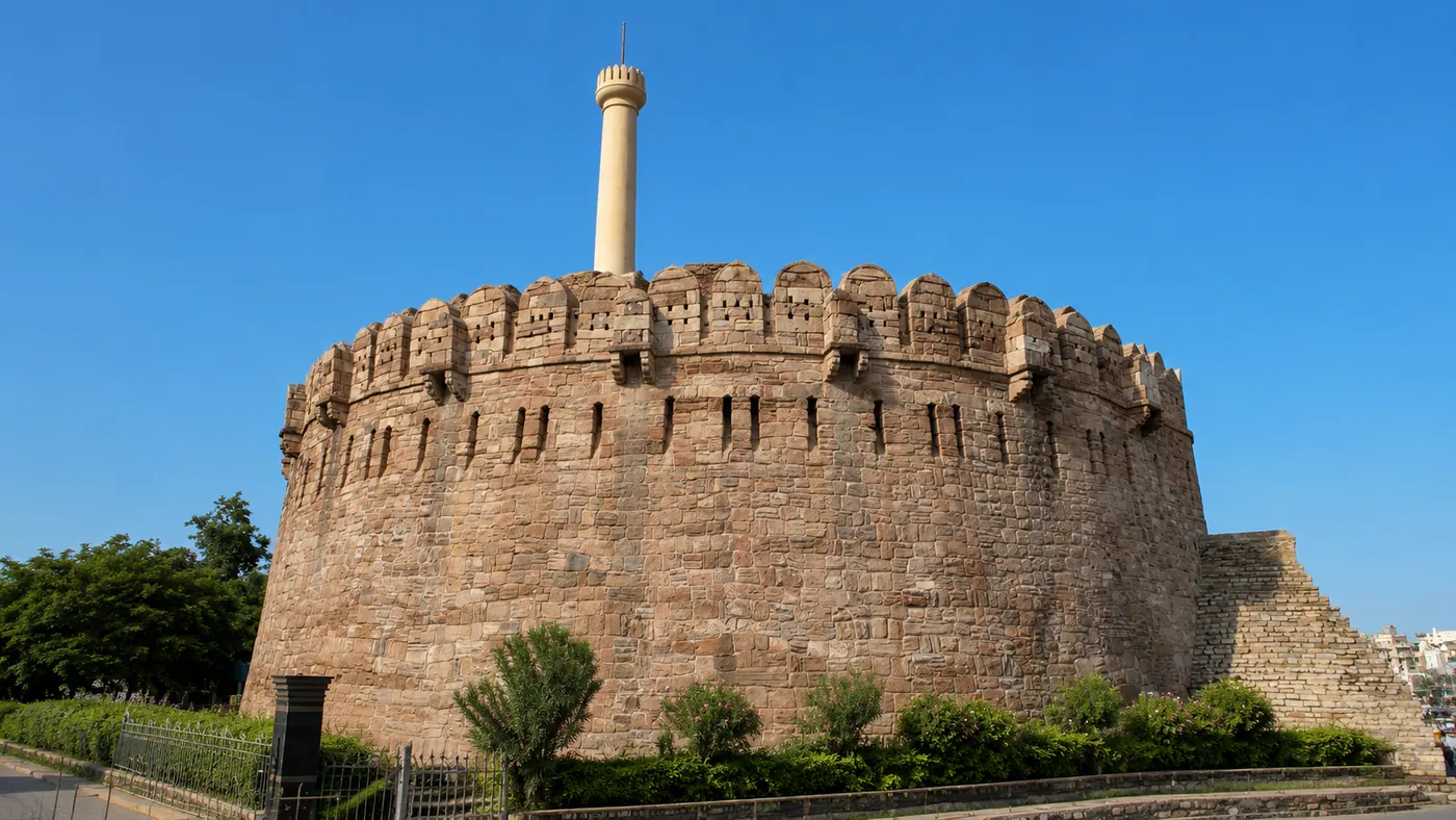 Konda Reddy Buruju fort with its gold minar against a blue sky, Kurnool
